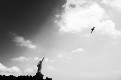 Low angle view of bird flying against sky