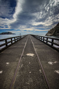 View of bridge over river against cloudy sky