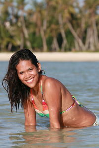 Portrait of smiling young woman in swimming pool