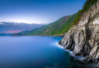 Scenic view of sea and mountains against sky