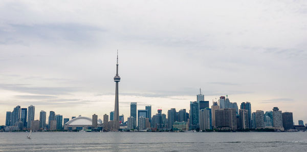 View of buildings in city against cloudy sky