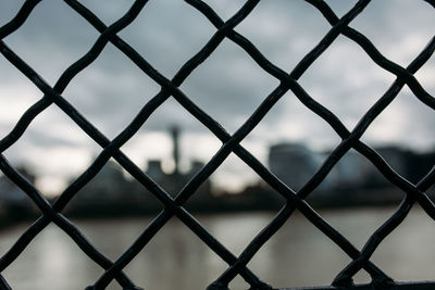 Full frame shot of chainlink fence against sky