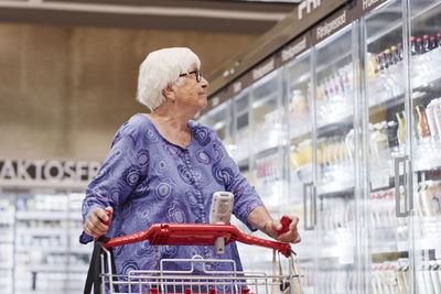 Senior woman doing shopping in supermarket