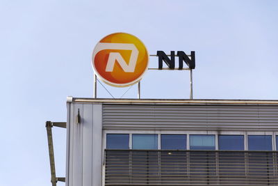 Low angle view of road sign against clear sky