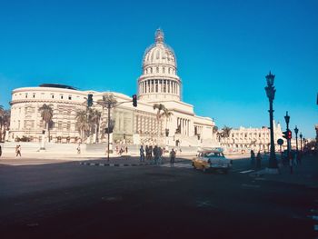 View of city street against blue sky