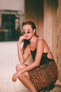 Portrait of a young woman sitting outdoors