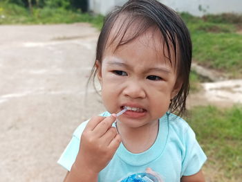 Close-up of cute baby girl eating lollipop