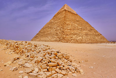 Stone wall in desert against sky