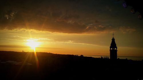 Silhouette building against sky during sunset