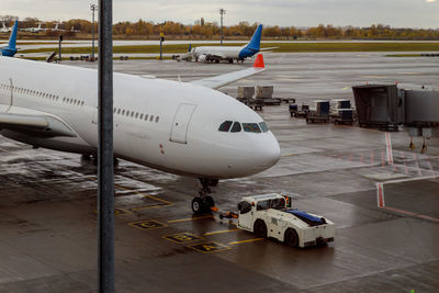 Airplane flying over airport runway