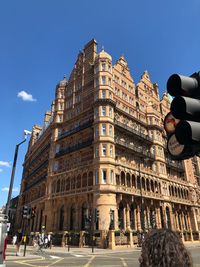 Low angle view of building by road in city against sky