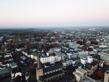 High angle view of city buildings against clear sky
