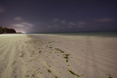 Scenic view of beach against sky at night