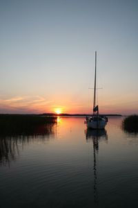 Sailboats in marina at sunset