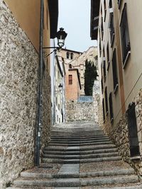 Low angle view of steps amidst buildings in town