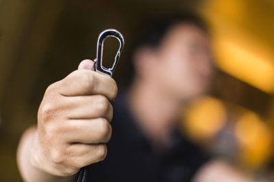 Close-up of man holding hook