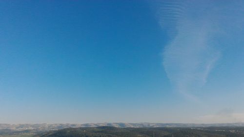 Scenic view of landscape against blue sky