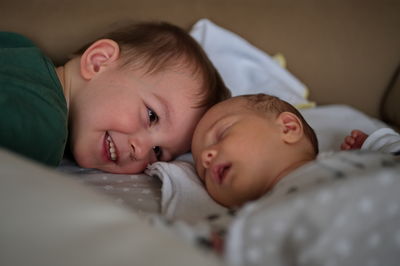 Close-up of cute baby boy sleeping on bed at home