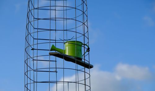 Low angle view of windmill against blue sky