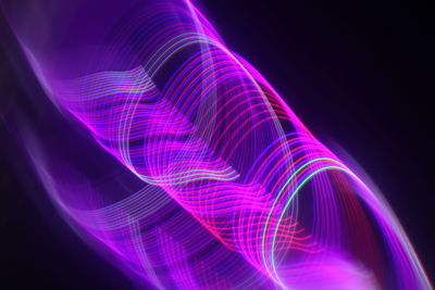 Close-up of light painting against black background
