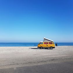 Scenic view of beach against clear blue sky