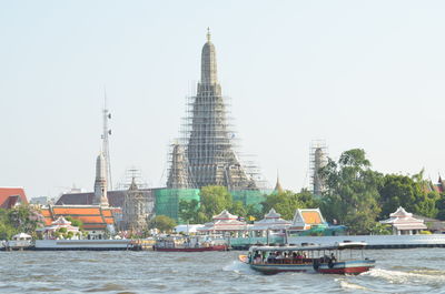 View of buildings in city against clear sky