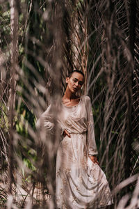 Woman standing by tree