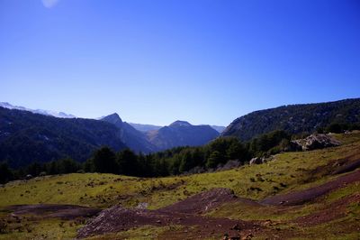 Scenic view of mountains against clear blue sky