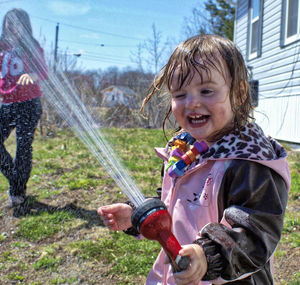 Happy girl holding shower