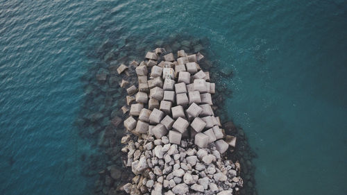 High angle view of pebbles by sea