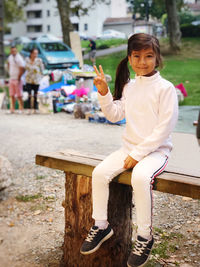 Portrait of girl sitting on bench