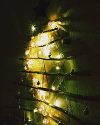 Low angle view of illuminated tree against sky at night