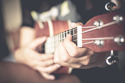 Close-up of man playing string instrument