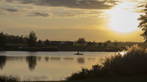 Scenic view of lake against sky during sunset