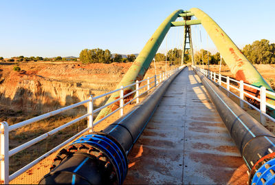 Pedestrian metal arch bridge over the strait of corinth.