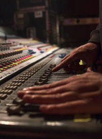 Cropped hands of dj using sound mixer