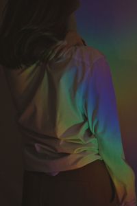Rear view of woman standing against gray background