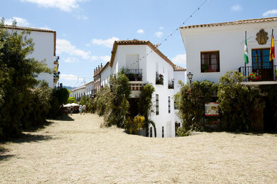 Street amidst buildings against sky