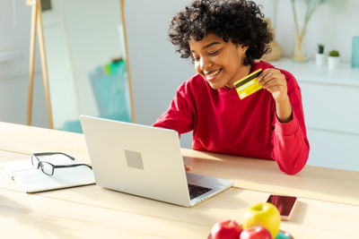 Young woman using laptop on table