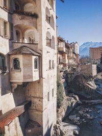 Old residential buildings by river mera