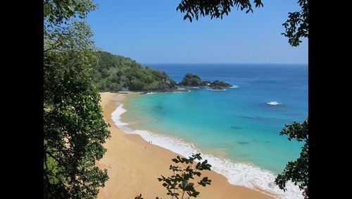 Scenic view of sea against blue sky