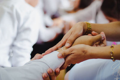 Midsection of couple holding hands