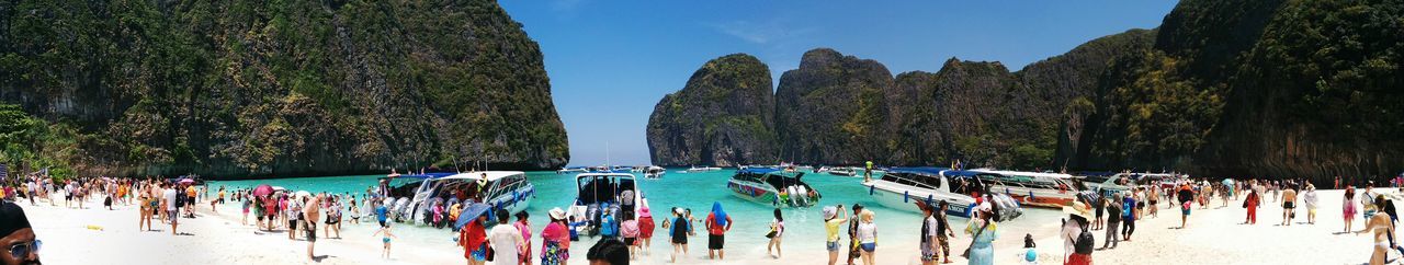 Panoramic view of people on beach against sky