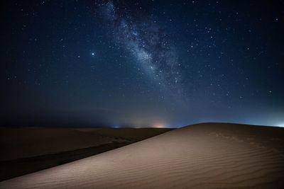 Scenic view of desert against sky at night