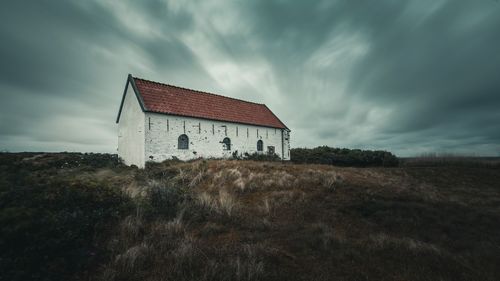 House on field against sky