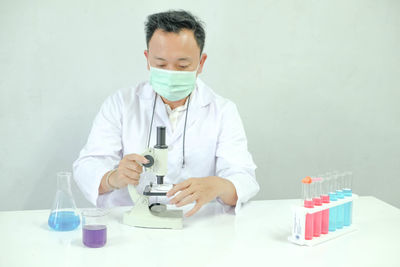 Scientist working at table in laboratory