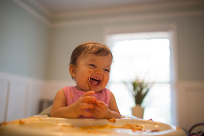 Happy boy having noodles at home