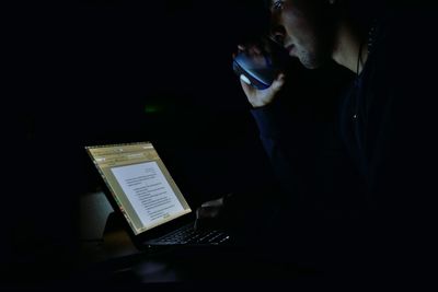 Man using smart phone at night