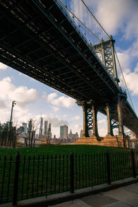 Bridge against cloudy sky
