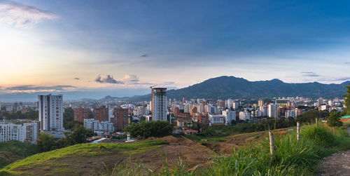 Buildings in city against sky during sunset